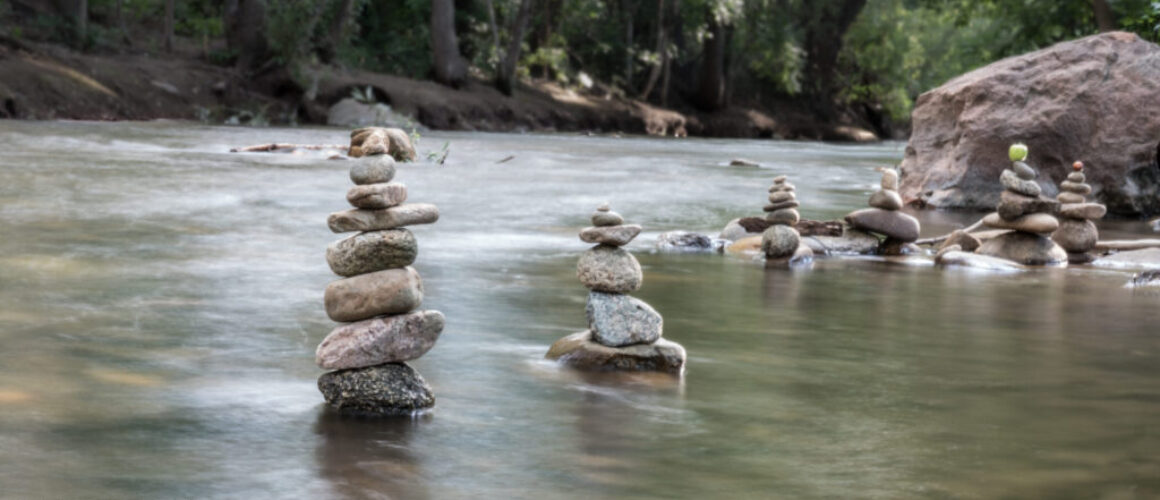 photo of rock cairns in creek