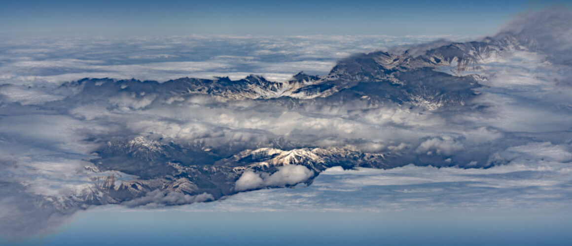 mirror image of land, clouds and sky